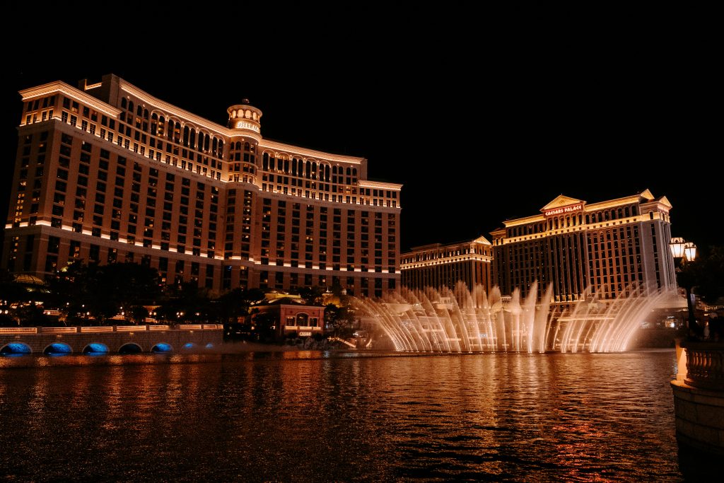 A stunning view of the Bellagio Hotel and fountains illuminated at night in Las Vegas, NV.