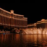 A stunning view of the Bellagio Hotel and fountains illuminated at night in Las Vegas, NV.